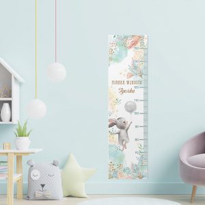 Wisząca miarka wzrostu z motywem wesołego zajączka dla dziecka. Na miarce zdobienia kolorowych kwiatów, piórek i pastelowych chmurek. Na środku miejsce na personalizację.