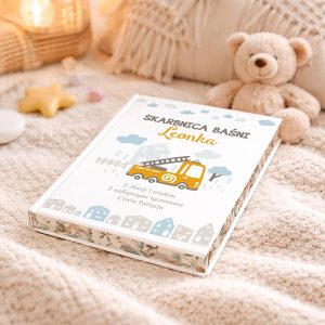 Książka 'Skarbnica Baśni Leonka' na beżowym kocyku, z ilustracją żółtego pojazdu i napisem, obok pluszowy miś i dekoracyjne elementy w tle.