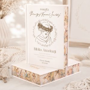 Biblia Anastasji w eleganckiej okładce z ilustracją postaci dziewczynki w wieńcu z kwiatów i ozdobnym napisem.