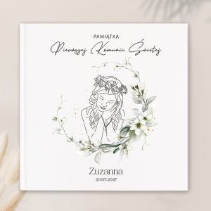Okładka książki pamiętającej o Pierwszej Komunii Świętej, z rysunkiem dziewczynki z kwiatową koroną i zamkniętymi oczami, otoczonej delikatnymi kwiatami i liśćmi, z napisem 'PAMIĄTKA' oraz imieniem 'Zuzanna' i datą '20.05.2027'.