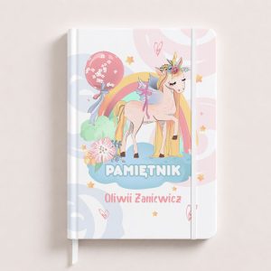 Notes with a cartoon unicorn and rainbow, featuring the text "PAMIĘTNIK" and the name "Oliwia Zanicz".