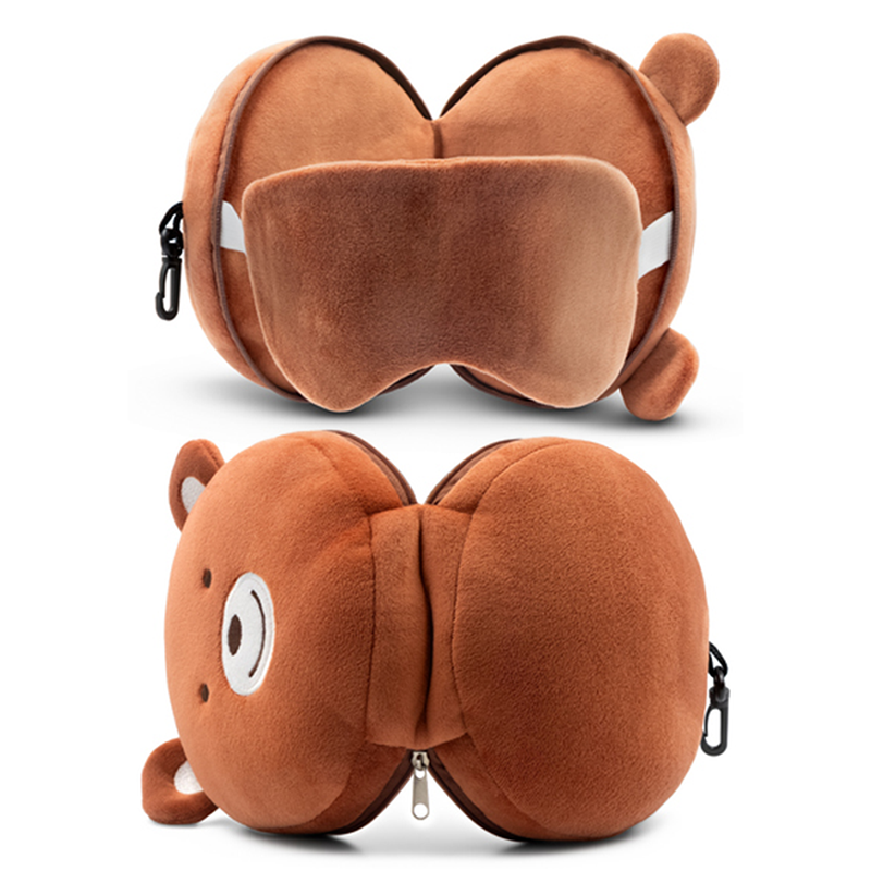 Poduszka w kształcie misia, wykonana z brązowego, miękkiego materiału, z wyrazem twarzy i uszami, otwierana na zamek błyskawiczny, przeznaczona do podróży lub relaksu.