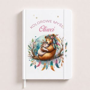 Notes with a white cover, featuring a bear wearing a floral crown hugging a smaller animal, with the text "Kolorowe myśli Oliwi."