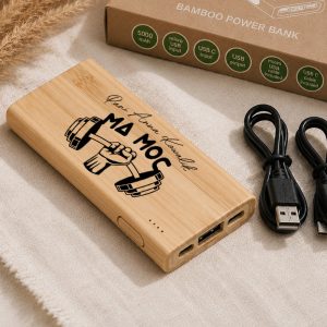 Bamboo power bank with a weightlifting graphic, featuring USB and micro USB ports, and a charging cable beside it.