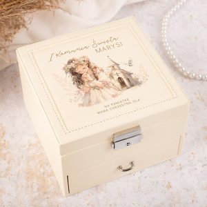 Elegancka szkatułka z ilustracją dziewczynki w białej sukience z kwiatami we włosach, z napisem 'I Komunia Świata Marysi' na wieczku, umieszczona na jasnym tle z elementami dekoracyjnymi.